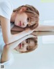 A couple of young women laying on top of a table.